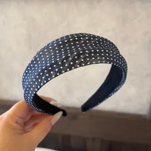Detailed view of the blue polka dot fabric headband, stylish hair accessory for daily wear.