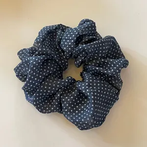 Dark blue polka dot satin hair scrunchie with stylish design for women's daily hair styling.