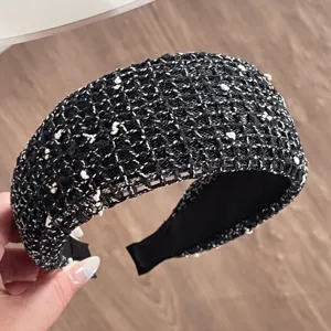 Close-up detail of a chic black and white tweed wide hair hoop, stylish mesh headband.