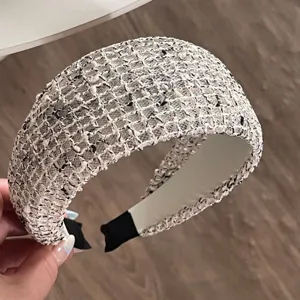 Detailed view of a chic wide tweed headband featuring a black and white mesh design.