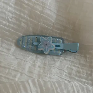 Cute blue star hair clip detail view, sweet hair accessory for kids and little girls.