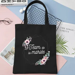 Detail shot of black canvas tote bag with floral frame design, spacious and stylish for daily use