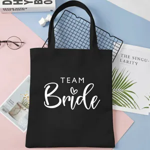 Black canvas tote bag with white TEAM Bride letter print, perfect for bachelorette party.