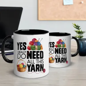 Close-up detail shot of a ceramic coffee mug featuring funny yarn graphic and text design.
