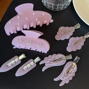 Vista dettagliata di mollette per capelli in acrilico rosa e fermagli con strass.