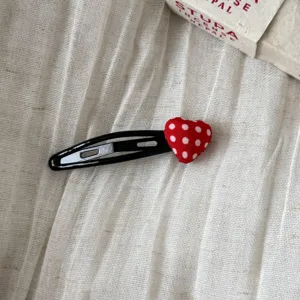 Red polka dot heart hair clip, cute snap hairpin for women and girls, stylish side hair styling.