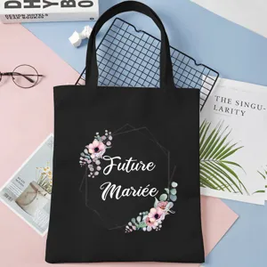 Black canvas tote bag with floral frame and future mariee print, stylish and roomy shopper.