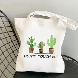 Borsa tote in tela bianca con graziosa stampa di cactus e design alla moda per uso quotidiano.