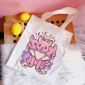 Detail view of pastel goth cute three-headed dog print canvas tote bag, aesthetic style.