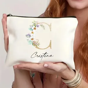 Bolso de maquillaje de lona personalizado con letra floral y cremallera para uso diario elegante.
