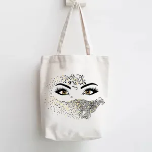 Canvas tote bag detail showing creative leopard eye graphic print design for casual daily use.