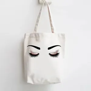 Canvas tote bag with elegant closed eyes and glitter eyelash print, daily shopping shoulder bag.