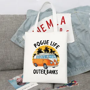 Nahaufnahme der weißen Segeltuch-Tasche mit Retro-Bus-Grafik und Palmen-Detail.