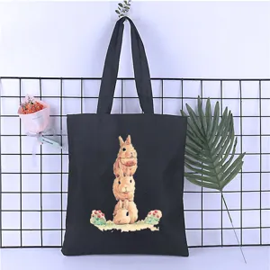 Black canvas tote bag with cute stacked rabbit print, casual shoulder shopping bag for students.