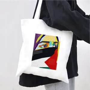 Canvas tote bag with geometric art face print, casual shoulder bag for daily shopping use.