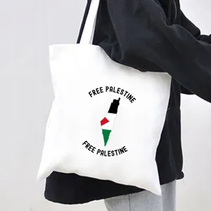 Close-up detail of a white canvas tote bag featuring political slogan and map print design.