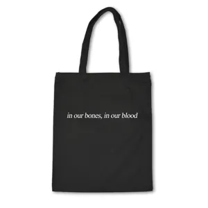 Black canvas tote bag with stylish white quote print, casual shoulder bag for daily use.