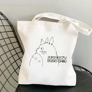 Detail view of white canvas tote bag featuring classic anime cartoon character print.