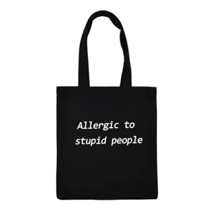 Close-up detail of black canvas tote bag with white slogan print, casual style daily use.