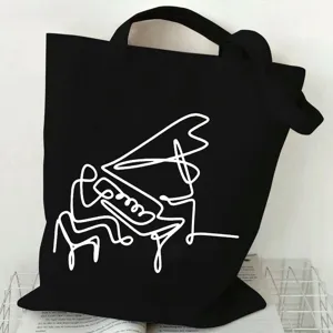 Minimalist black canvas tote bag with white line art piano player graphic for daily commute.