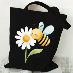 Bolso tote de lona negra con bonito estampado de abeja y margarita, ideal para el día a día.