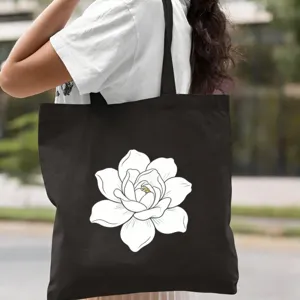 Sac cabas noir en toile décontracté avec imprimé floral blanc, parfait pour le travail et les cours.