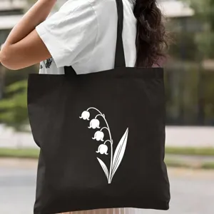 Sac cabas en toile noir avec imprimé muguet blanc, sac à épaule élégant pour usage quotidien.