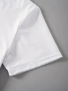 Close up view of plain white short sleeve t-shirt showing fine fabric texture and neat stitching.