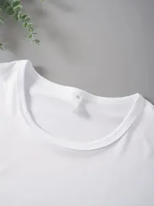 Close-up detail shot of white short sleeve t-shirt neckline with size XL neck label.