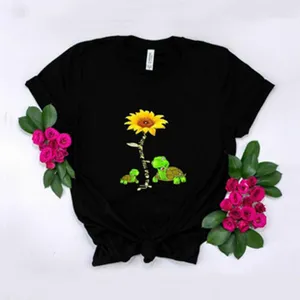 Women's black short sleeve t-shirt featuring sunflower and turtle graphic, casual tee.