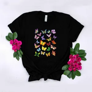 Close-up detail of black short-sleeve t-shirt with colorful butterfly print and floral decor.