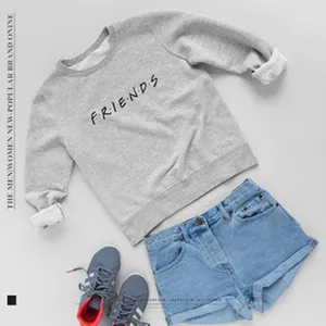 Detailed flat lay of casual grey Friends letter print sweatshirt with denim shorts outfit.
