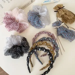 Detail shot of Korean style leopard print mesh hair scrunchies and chic headbands.