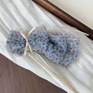 Blue leopard print mesh hair bow detail, chic sheer fabric scrunchie with ribbon.