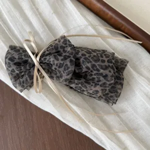 Korean leopard print mesh hair scrunchie with cute ribbon detail for stylish low ponytail styling.
