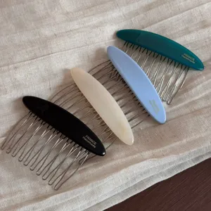 Close-up detail of acetate insert combs featuring metallic teeth and multi-color options.