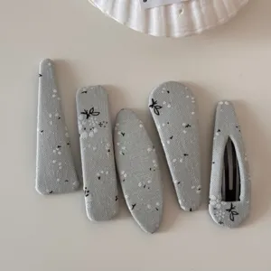 Detailed view of grey floral fabric hair clips set, elegant geometric BB pins for daily wear.