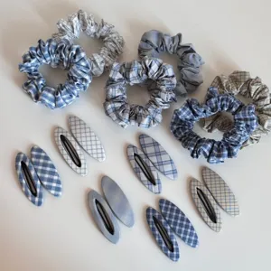 Detail view of blue plaid hair scrunchies and snap hair clips set, cute hair accessories.