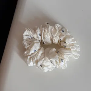 White ruffled hair scrunchie with cute small dot pattern, soft and elastic fabric for daily use.