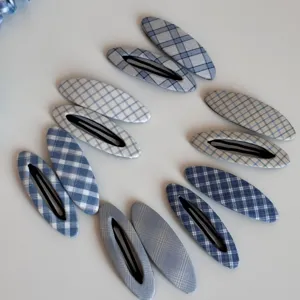Detailed shot of Korean style blue plaid BB hair clips, cute side hairpins for daily wear.