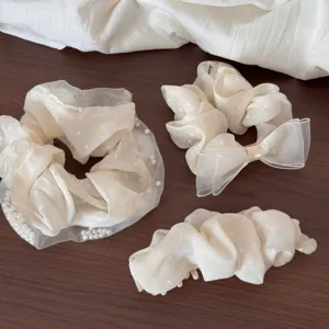 Detailed view of elegant organza hair scrunchies set with pearls and cute heart polka dots.