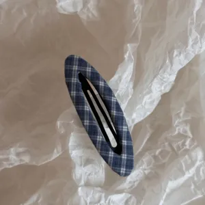Close up detail of a cute blue plaid fabric snap hair clip, perfect for daily styling.
