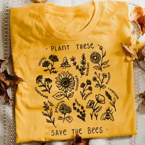 Detailed view of the yellow botanical print t-shirt featuring save the bees graphic design.