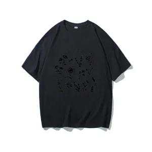 Close-up detail of the black t-shirt featuring the plant these save the bees graphic.