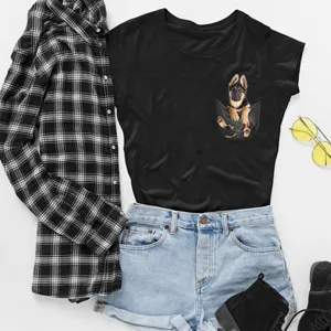 Detail view of black short-sleeve t-shirt with cute puppy pocket print, stylish outfit flat lay.