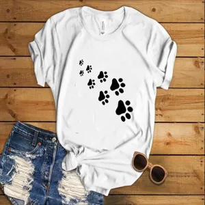 Details of white short sleeve t-shirt with black paw print graphic and casual denim shorts.
