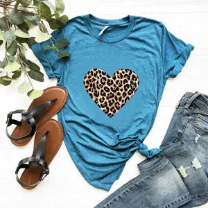 Detailopname van een blauw t-shirt met korte mouwen en luipaard hart print op wit hout.