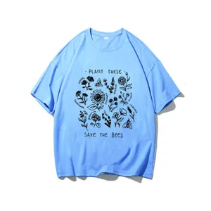 Close-up detail of the light blue graphic t-shirt featuring botanical bee and plant prints.