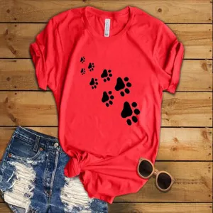 Close-up detail view of red short sleeve t-shirt with black paw print graphic design.