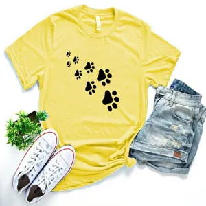 Detail view of yellow short sleeve t-shirt with cute black paw print pattern and casual design.